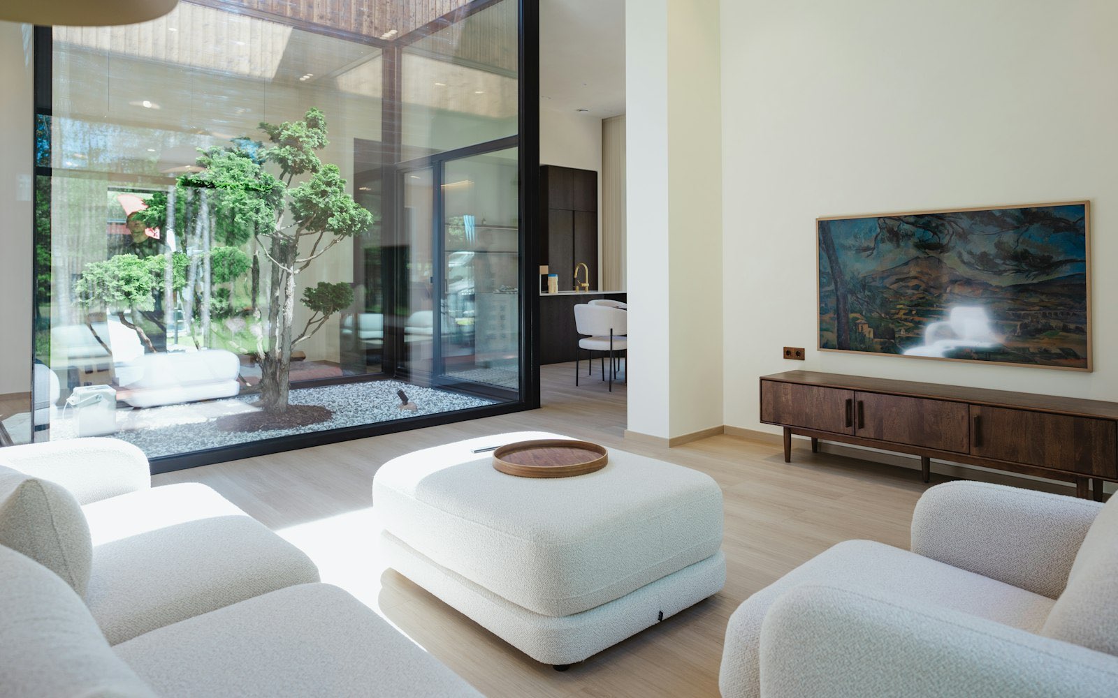 Bright modern interior with anthracite framed glazing looking onto a planted garden